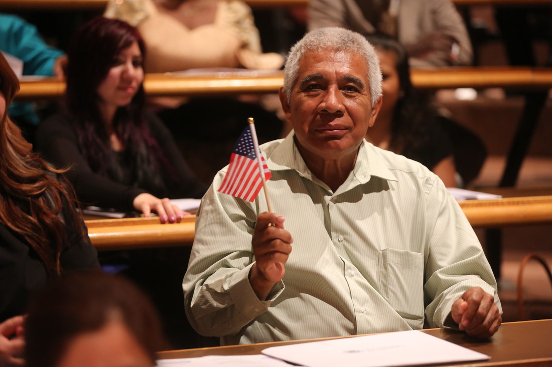 A new U.S. citizen holding an American flag