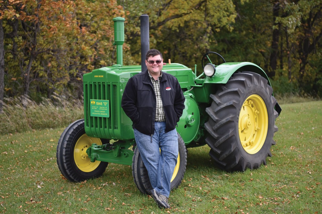 Jordan DeBoer standing in front of a tractor