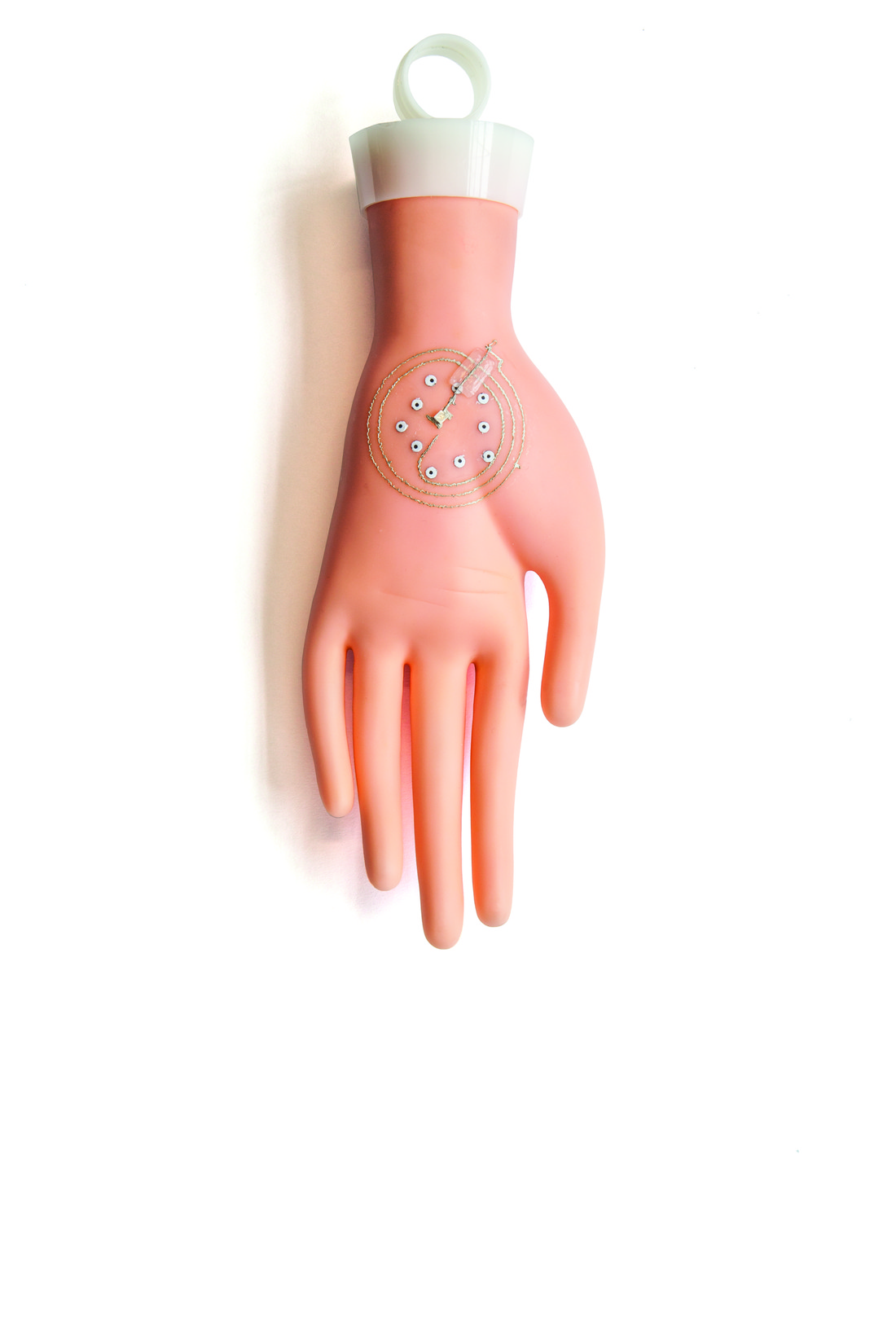 Image of mannequin's hand with electronic wiring printed on it