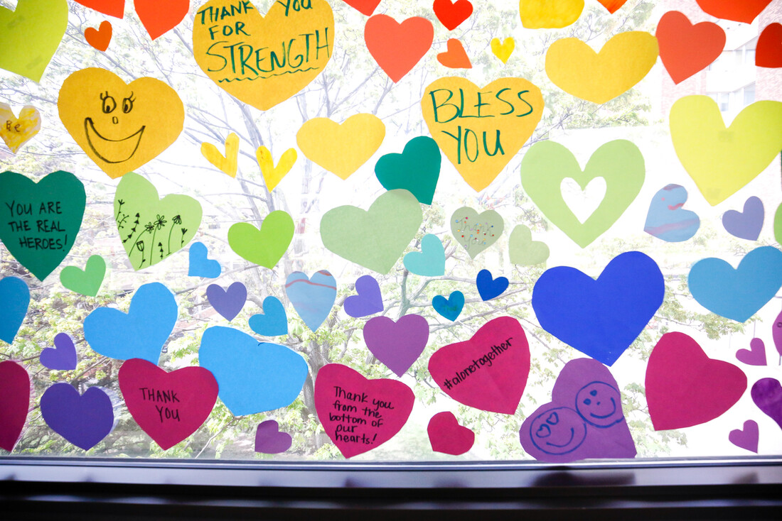 Window with hearts bearing words of thanks for health care workers