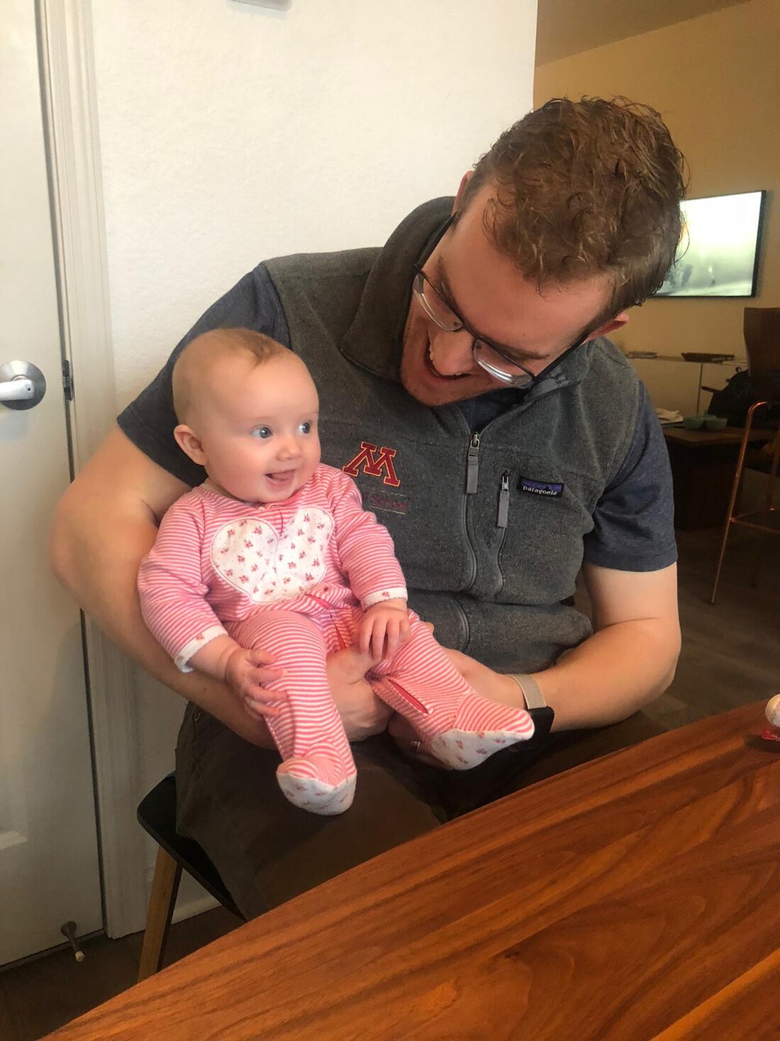 Tom Schmidt holding a baby