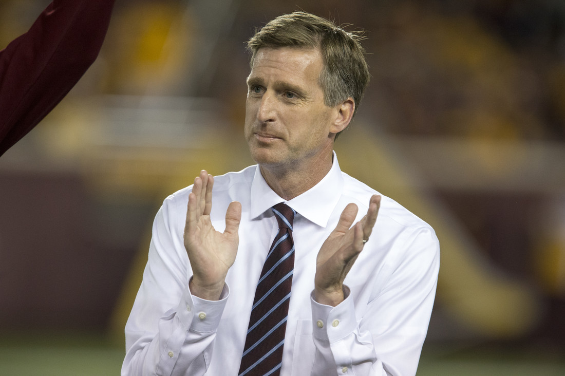 University of Minnesota Athletic Director Mark Coyle clapping